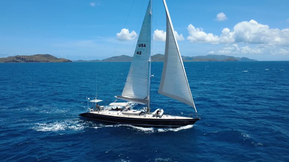 Drone view of Cap II sailing with two headsails set.